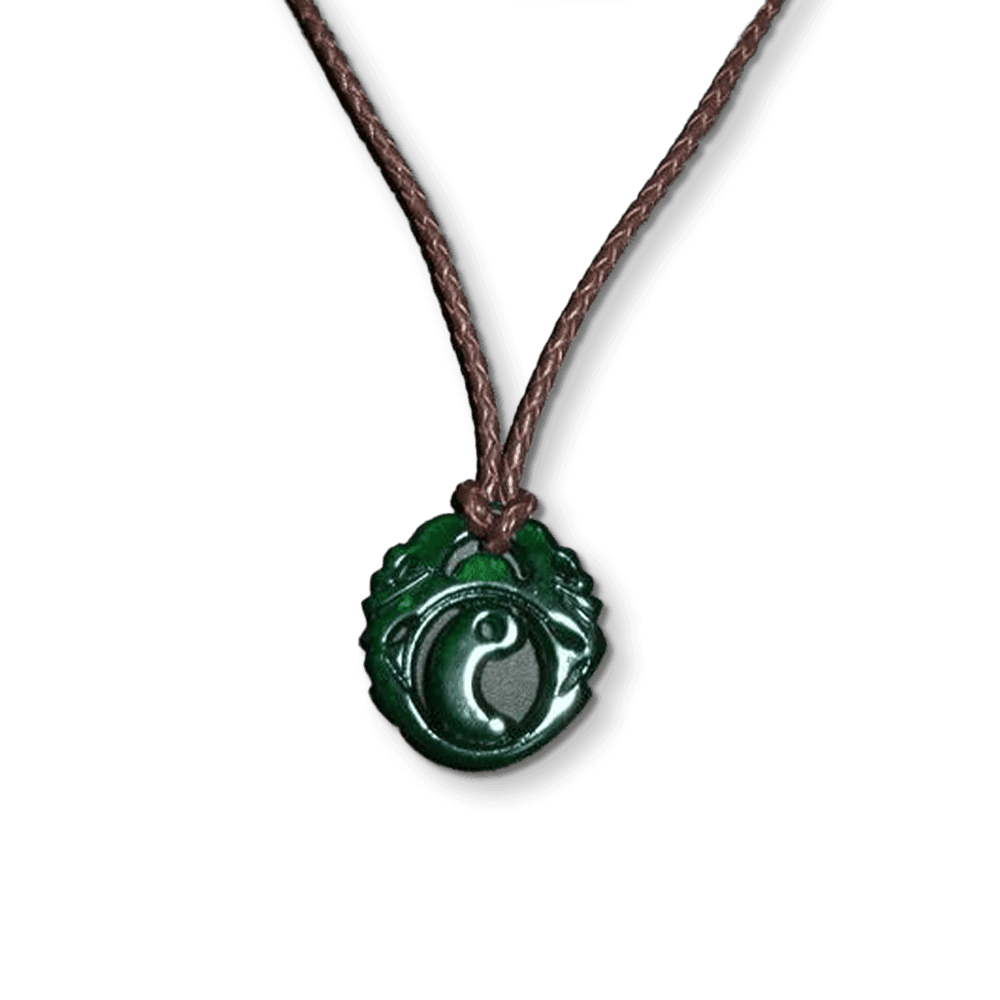 A dark green pendant etched with an ancient symbol, strung on a leather cord.